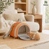 Nibbly small pet crossbody carrier in a warm living room with a relaxed hamster